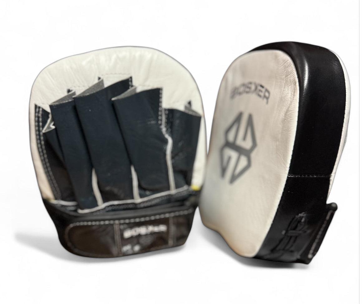Pair of black and white focus mitts with a brand logo on a white background